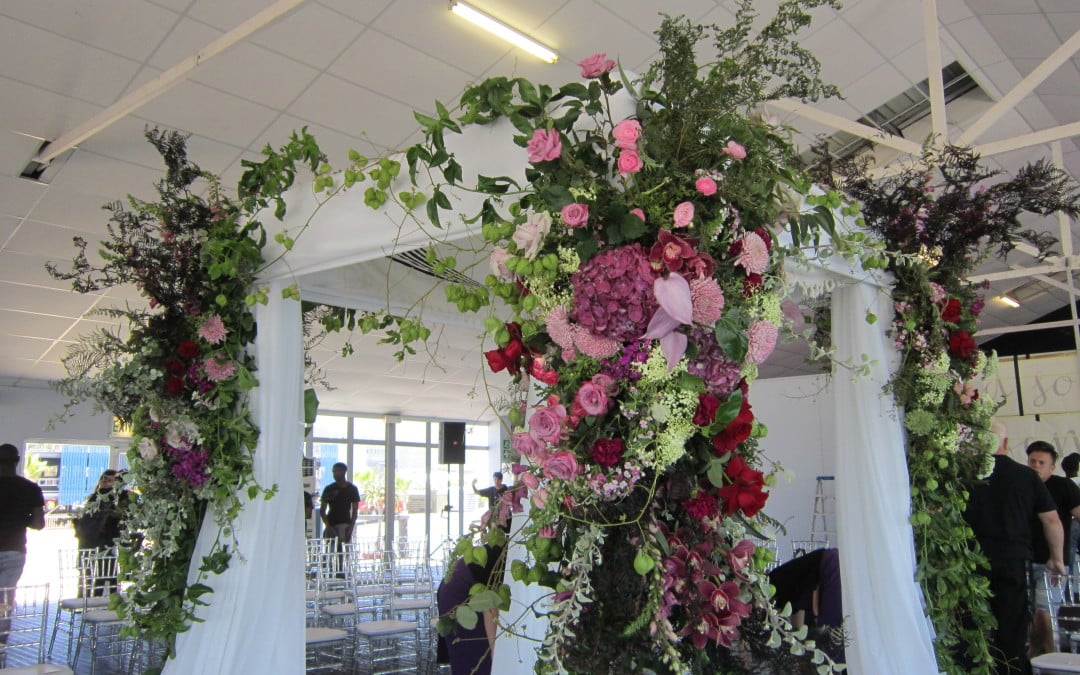 Wedding setup at The Lookout Marquee, V&A Waterfront, featuring a partition in translucent black chiffon and a chuppah draped in white chiffon by The Events Draping Co.