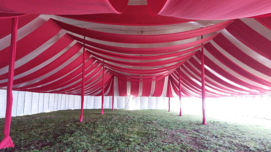 Red and white striped ceiling draping in a marquee setup by The Events Draping Co.