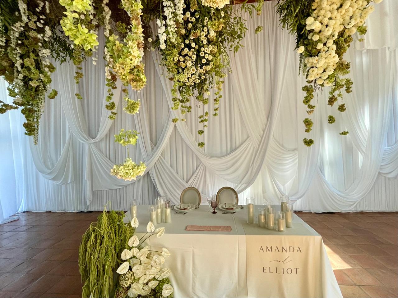 Bridal backdrop feature with overdrapes and pickups in white fabric