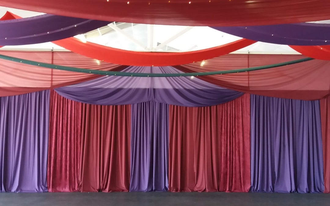 Moroccan-themed corporate party at The Lookout, V&A Waterfront, featuring earthy-colored ceiling strip draping and fairy lights by The Events Draping Co.