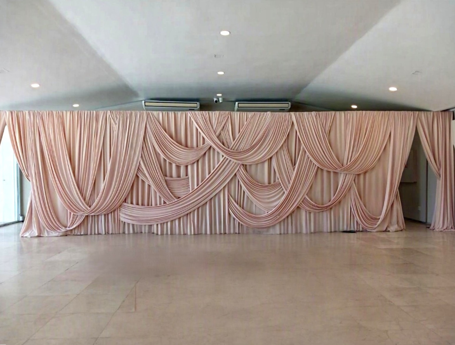 Cream trilobal bridal backdrop with overdrapes by The Events Draping Co.
