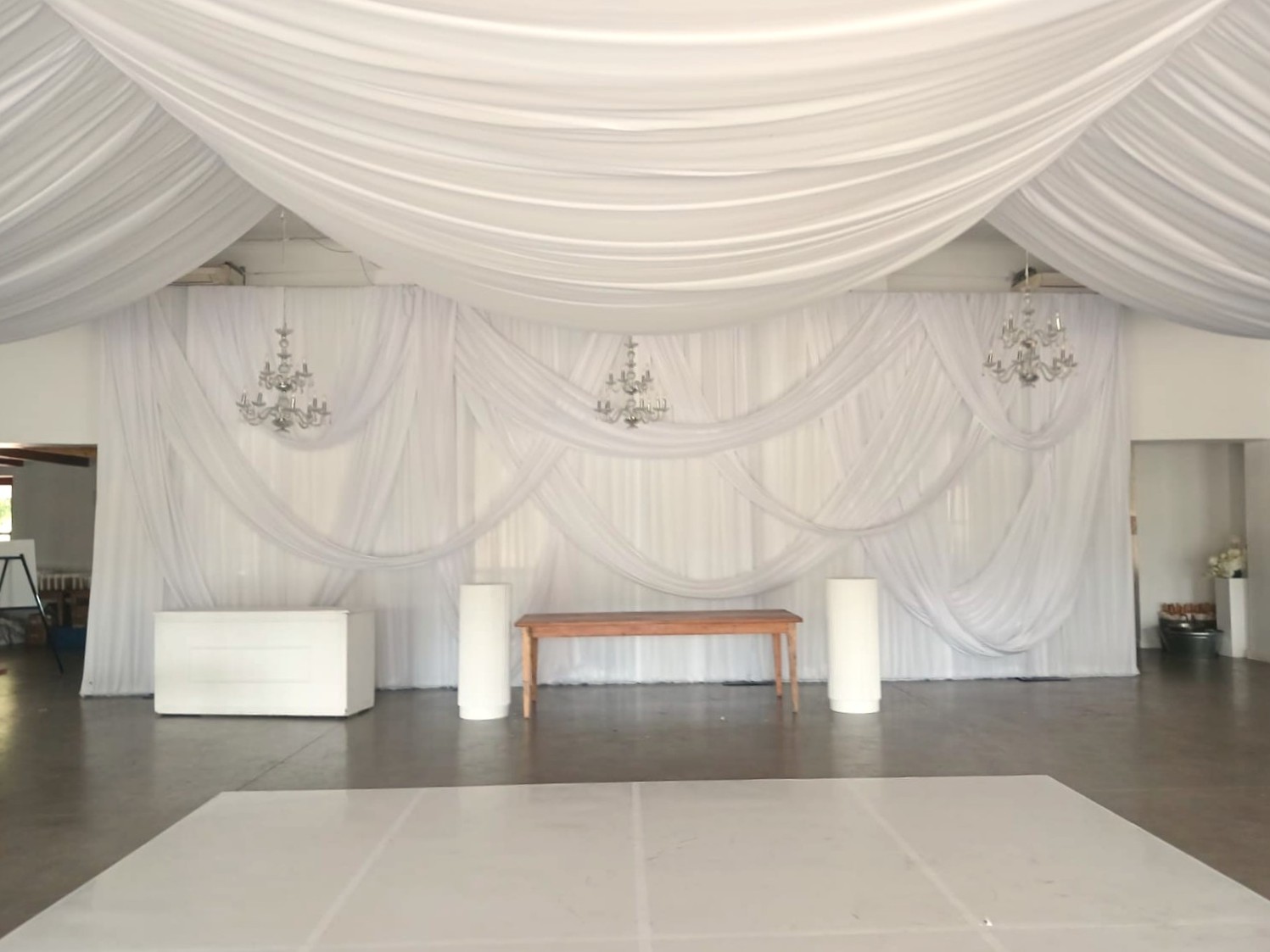 Wedding backdrop and full ceiling swags in white by The Events Draping Co.