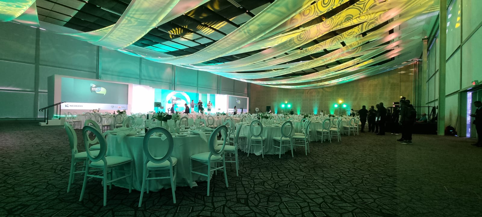 Crossed ceiling draping swags in large area for a corporate function by The Events Draping Co.