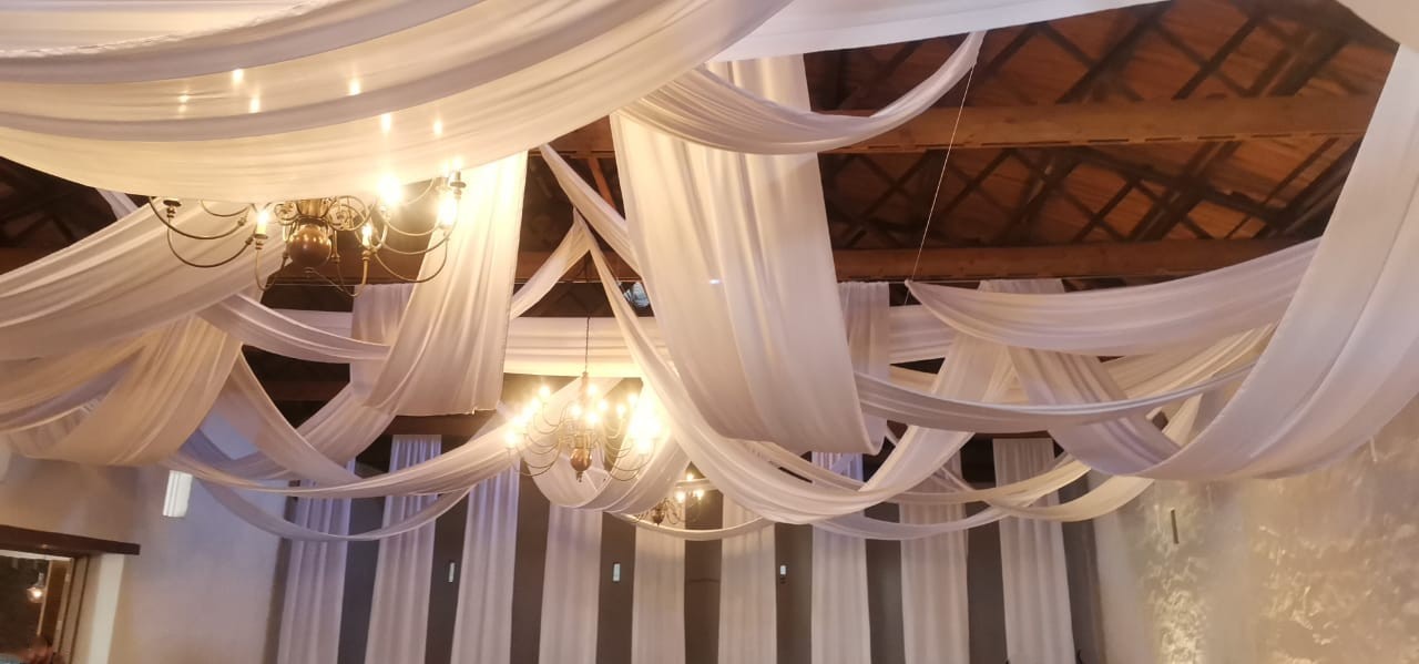 Random ceiling swags with wall drops by The Events Draping Co.