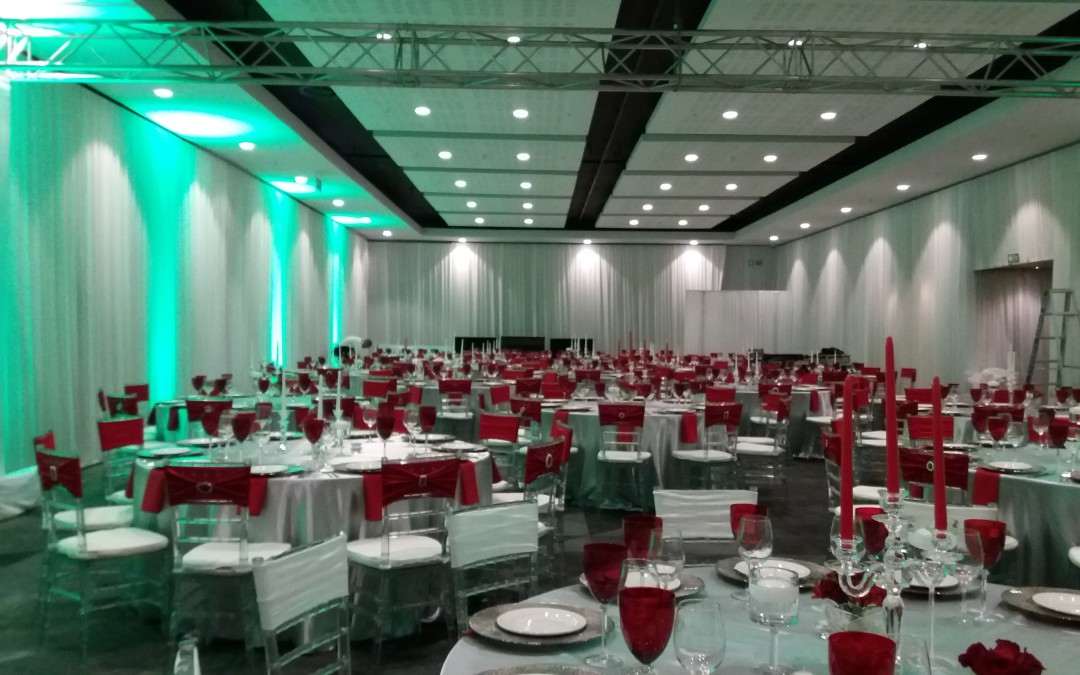 Corporate gala evening setup at Century City Conference Centre, Cape Town, featuring bright red draping on walls and pillars by The Events Draping Co.