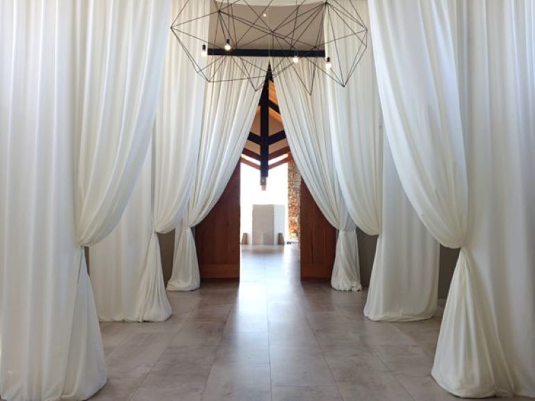 A series of draped entrance features for a wedding by Events Draping