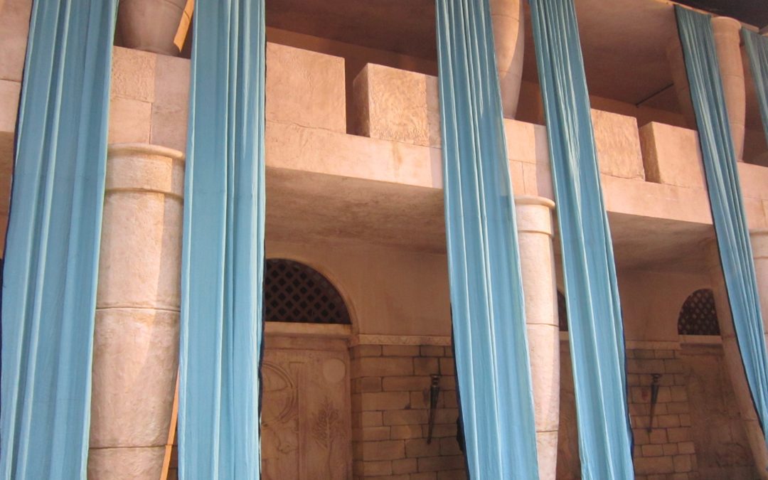 Set for Samson the Movie, featuring aged burgundy and red draping in the harem room and blue draping on temple pillars, crafted by The Events Draping Co.