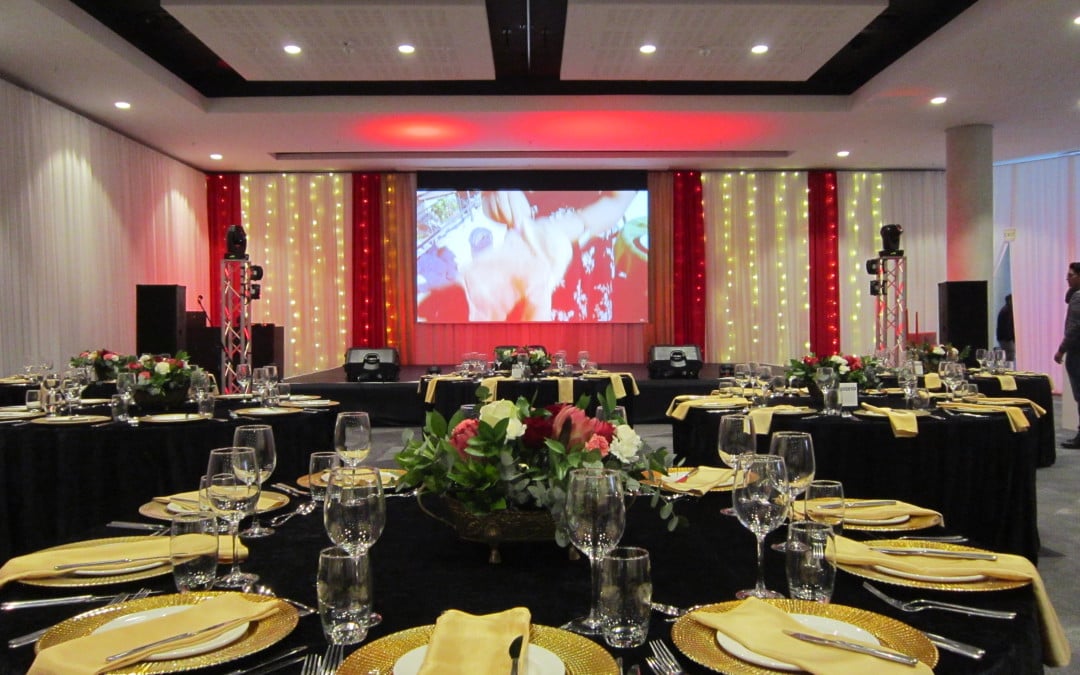 Gala dinner for Turkish Airlines' 10th anniversary at Century City Conference Centre, featuring white draping with red and gold highlights and fairy lights by The Events Draping Co