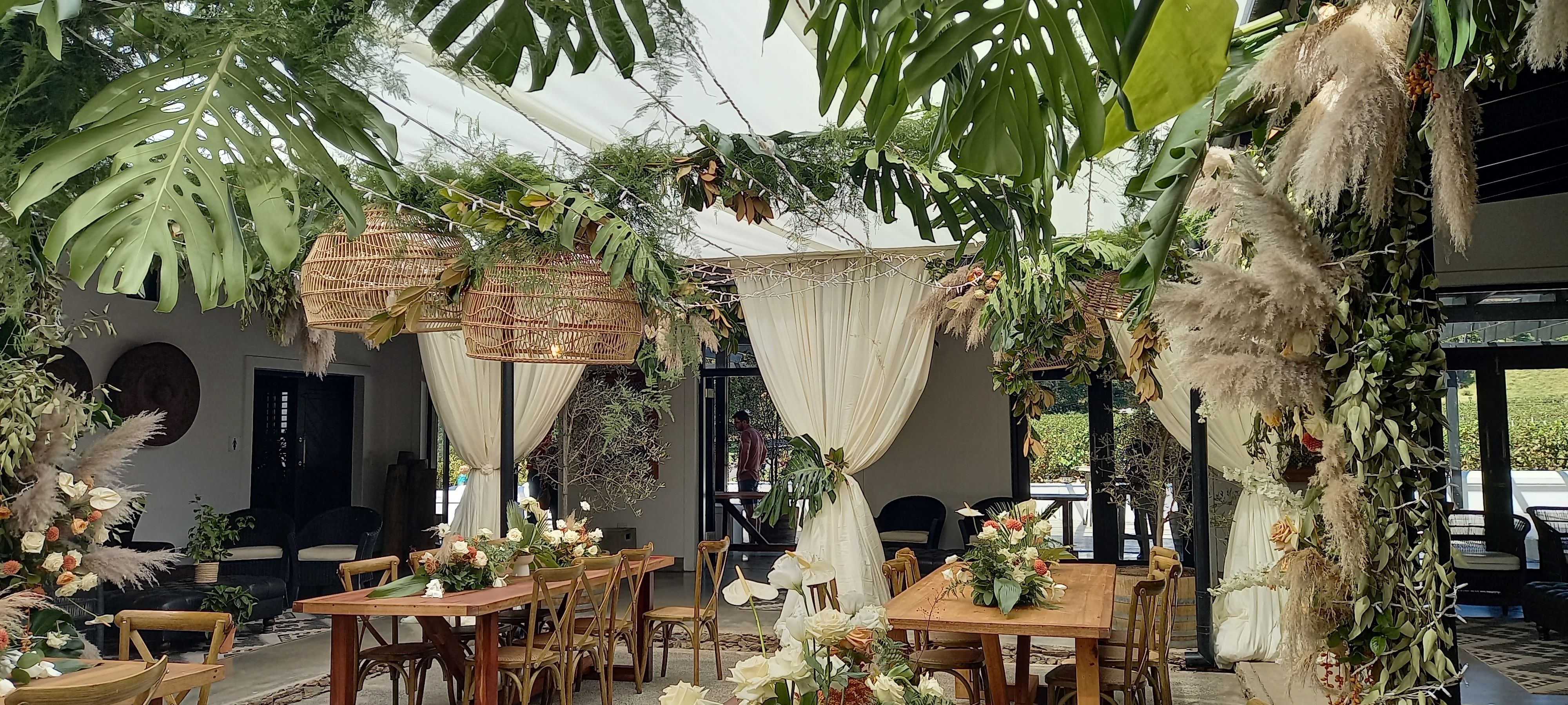 Wedding draping with greenery and floral accents by The Events Draping Co.
