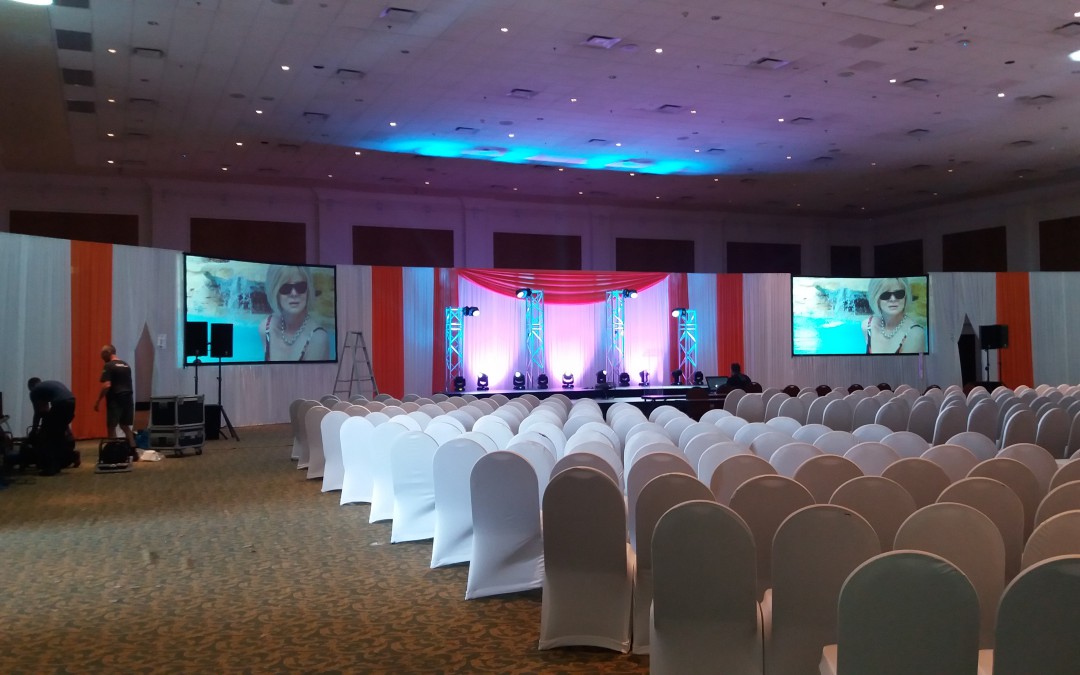 Network 21 seminar at Market Hall, GrandWest Casino, Cape Town, featuring white and orange draping with an orange swag by The Events Draping Co.