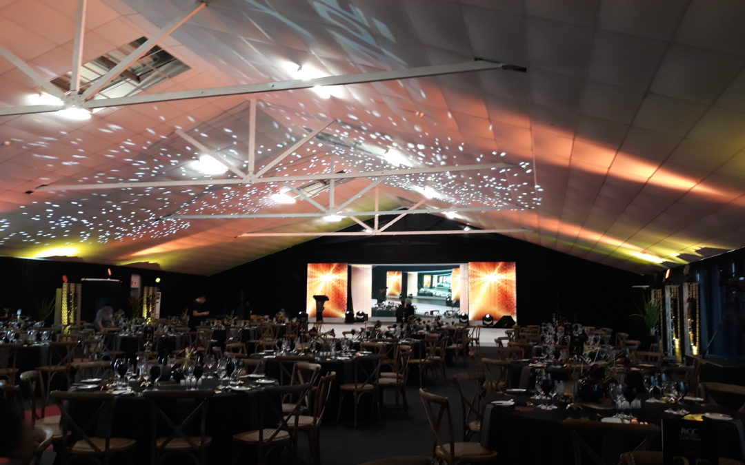 Gala dinner setup at The Lookout, V&A Waterfront, Cape Town, featuring black chiffon draping for wall dividers and eaves by The Events Draping Co. for the Regional Chairman’s Council gala dinner.