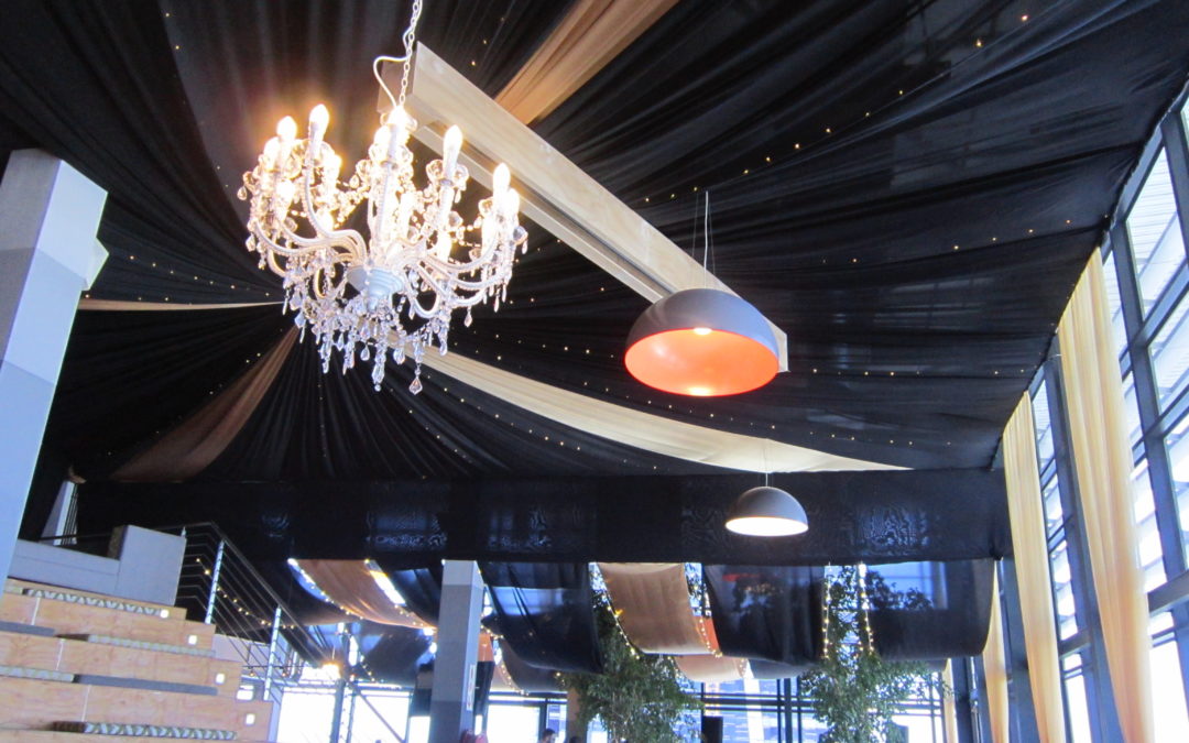 Great Gatsby-themed corporate party at 99c Agency in Cape Town, featuring black fabric strips with gold velour details and fairy lights by The Events Draping Co.