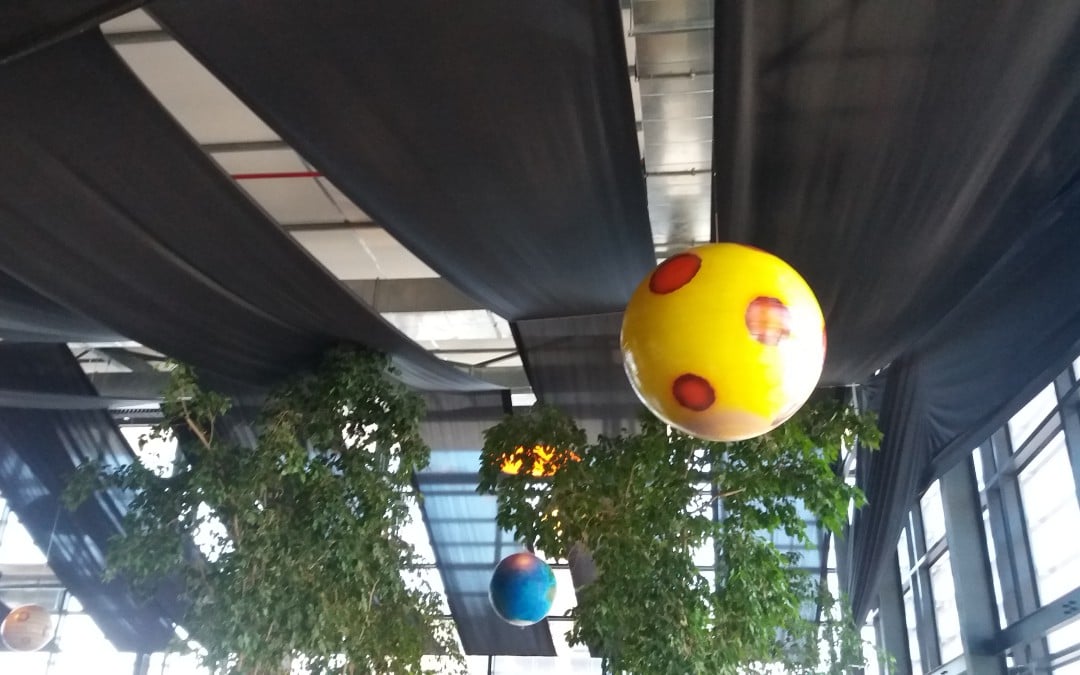 Corporate party at 99c Advertising Agency with a Space Disco theme, featuring black ceiling draping and hanging planets by The Events Draping Co.