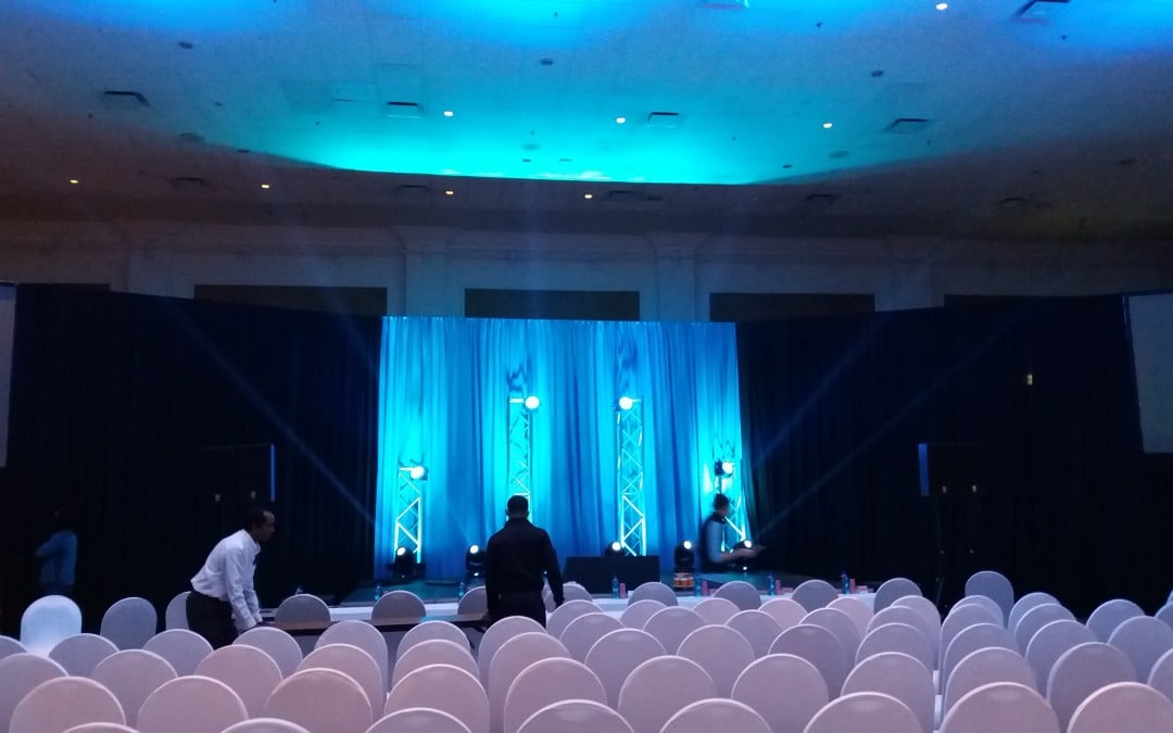Corporate event for Network 21 at Grand West Casino, Cape Town, featuring blue and black draping by The Events Draping Co. with uplighting provided by Next Productions.
