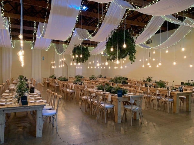 Summer wedding setup at Nooitgedacht Estate in the Cape Winelands, featuring elegant draping by The Events Draping Co.