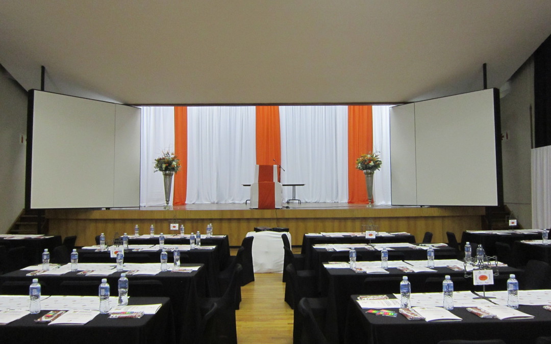 CCC Conference setup at Northlink College in Bellville, featuring white draping with burnt orange highlights by The Events Draping Co.