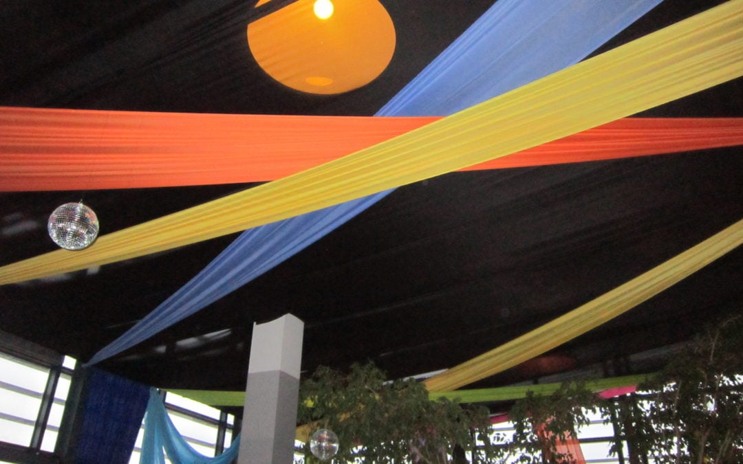 80s disco party setup at 99c Agency in Cape Town, featuring vibrant draping by The Events Draping Co.