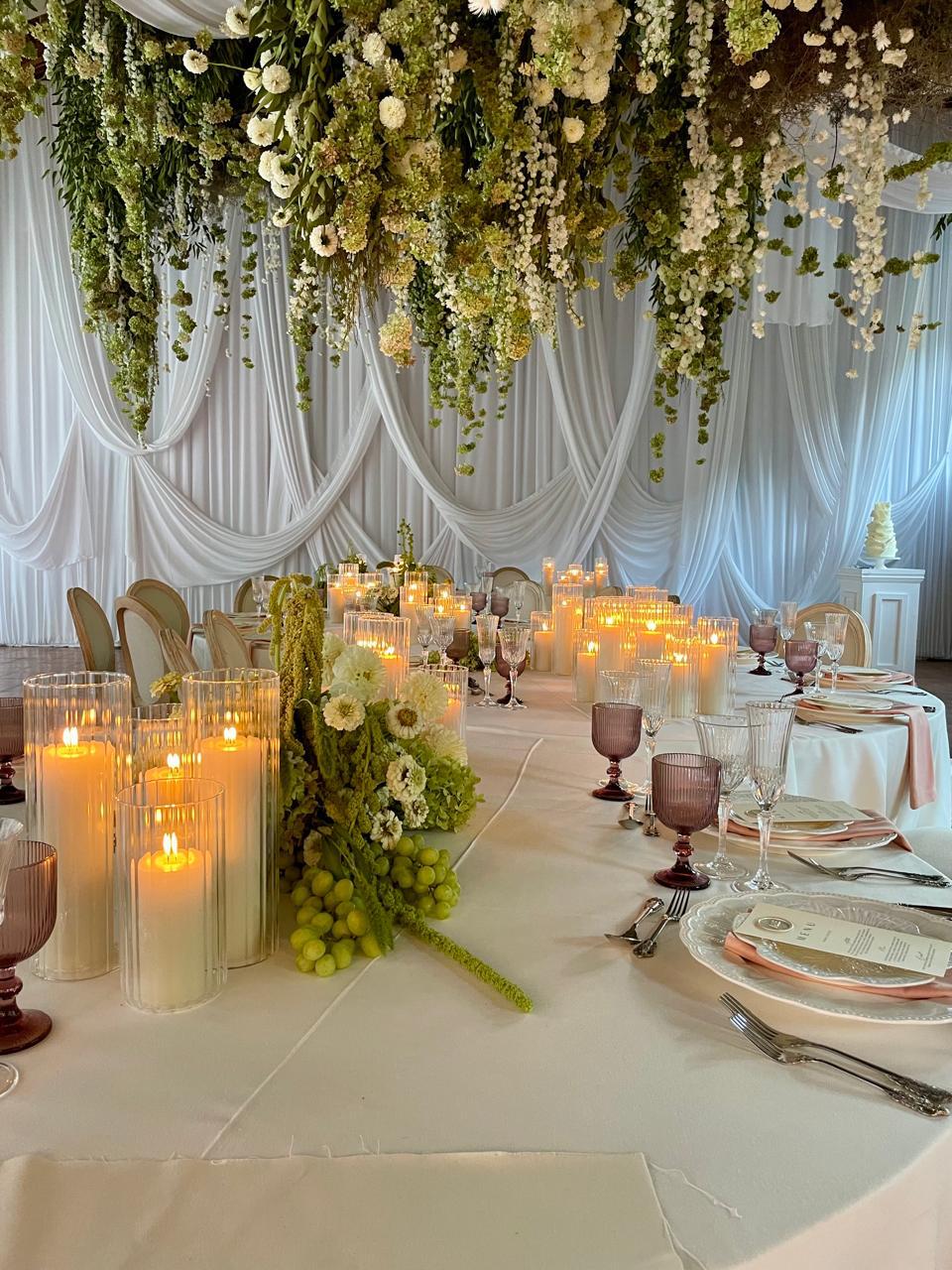 Bridal backdrop feature with overdrapes and pickups in white fabric