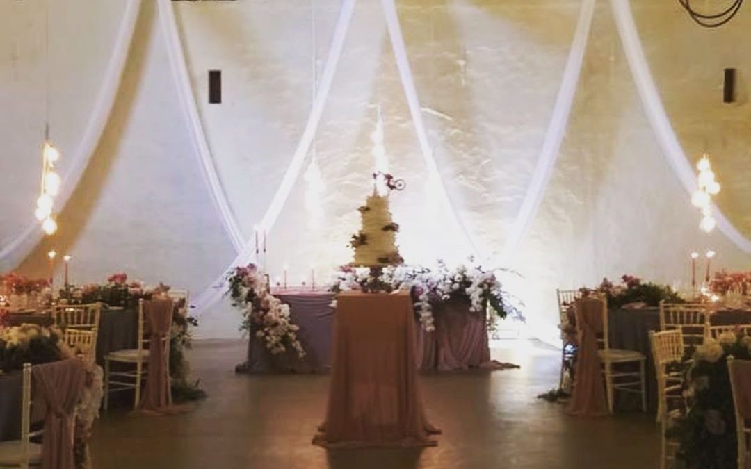 Wedding celebration setup at Nooitgedacht Estate in the Cape Winelands, featuring elegant draping by The Events Draping Co.