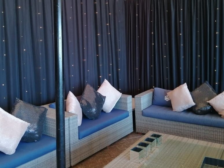 Party setup at Doodles Restaurant, Bloubergstrand, Cape Town, featuring elegant draping by The Events Draping Co.