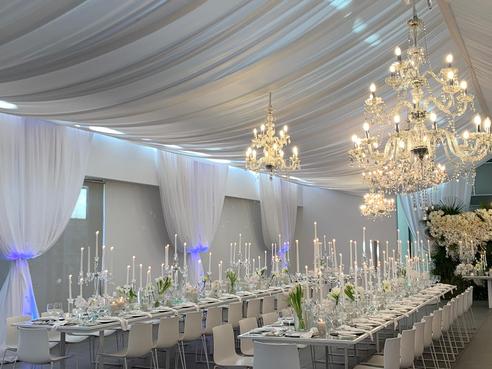 Fully draped ceiling with chandeliers for a formal event by The Events Draping Co.